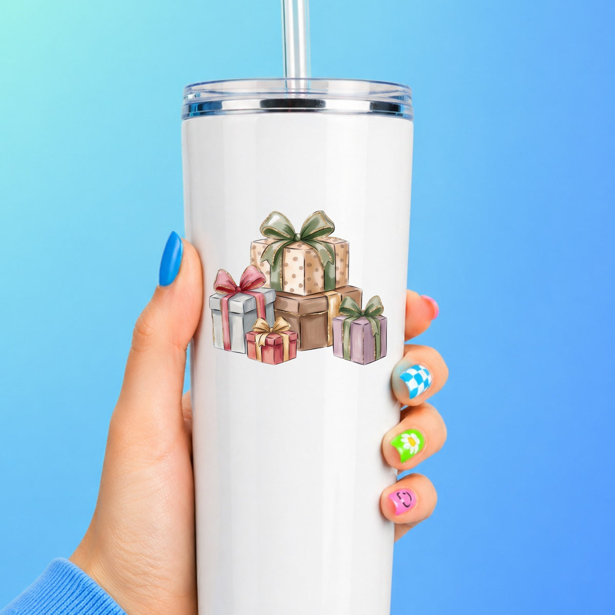 Pastel Gift Box Stack UV DTF sticker applied to a white straw tumbler on a blue background