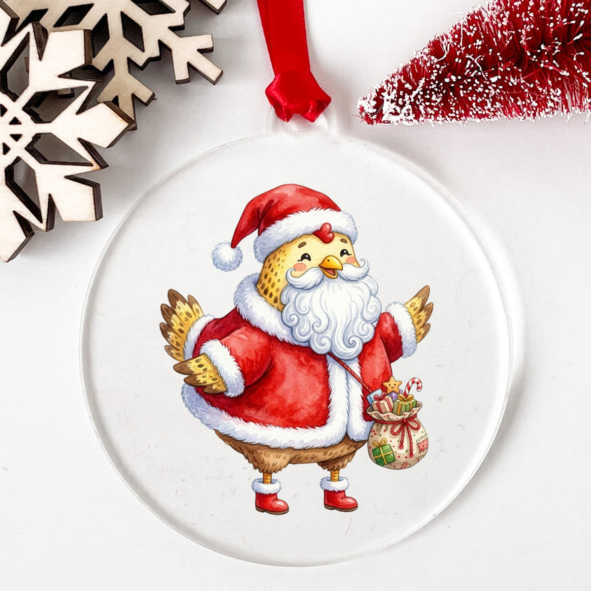Chicken Dressed As Santa Claus UV DTF sticker applied to a clear round acrylic ornament with a red ribbon