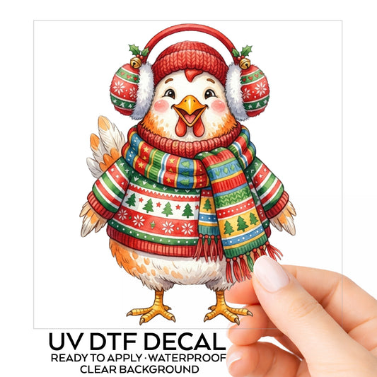 Ugly Sweater Chicken With Earmuffs UV DTF sticker on its backing card, held in hand