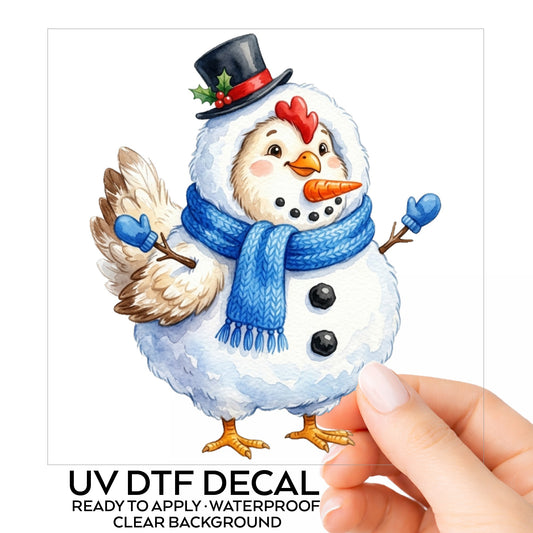Chicken In Snowman Costume UV DTF sticker on its backing card, held in hand