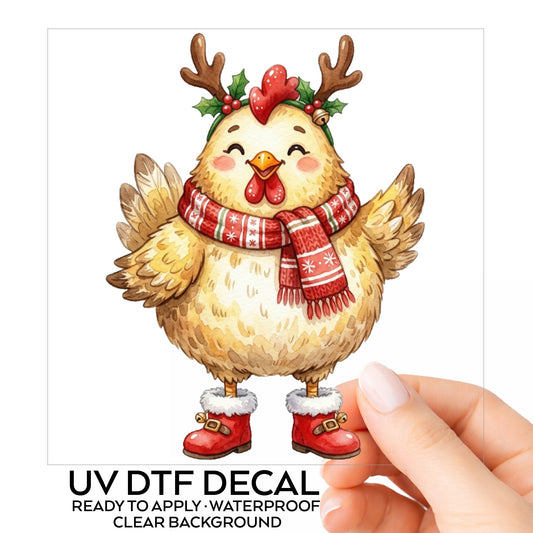 Yellow Chicken With Antlers And Red Boots UV DTF sticker on its backing card, held in hand