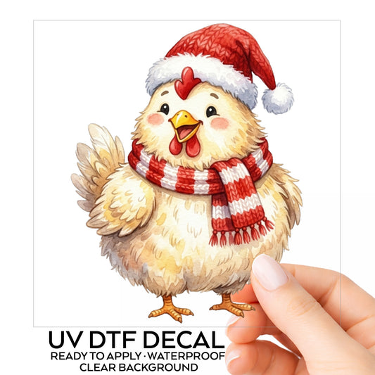 Santa Hat Chicken In Striped Scarf UV DTF sticker on its backing card, held in hand
