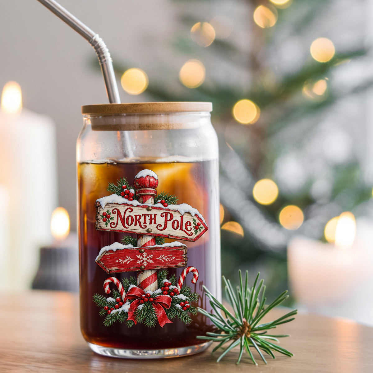 North Pole Sign UV DTF sticker applied to a glass can cup of iced coffee with a straw