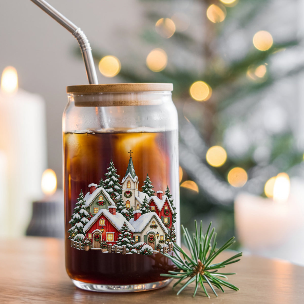 Snowy Christmas Village With Church UV DTF sticker applied to a glass can cup of iced coffee with a straw