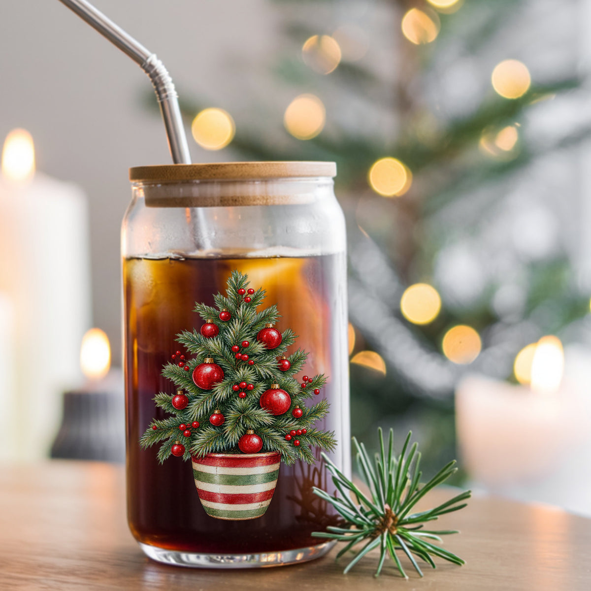 Potted Christmas Tree With Red Ornaments UV DTF sticker applied to a glass can cup of iced coffee with a straw