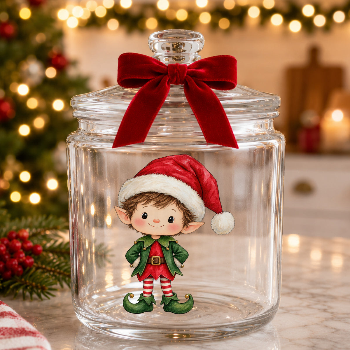 Christmas Elf Boy In Santa Hat UV DTF sticker applied to a glass candy jar tied with a red bow
