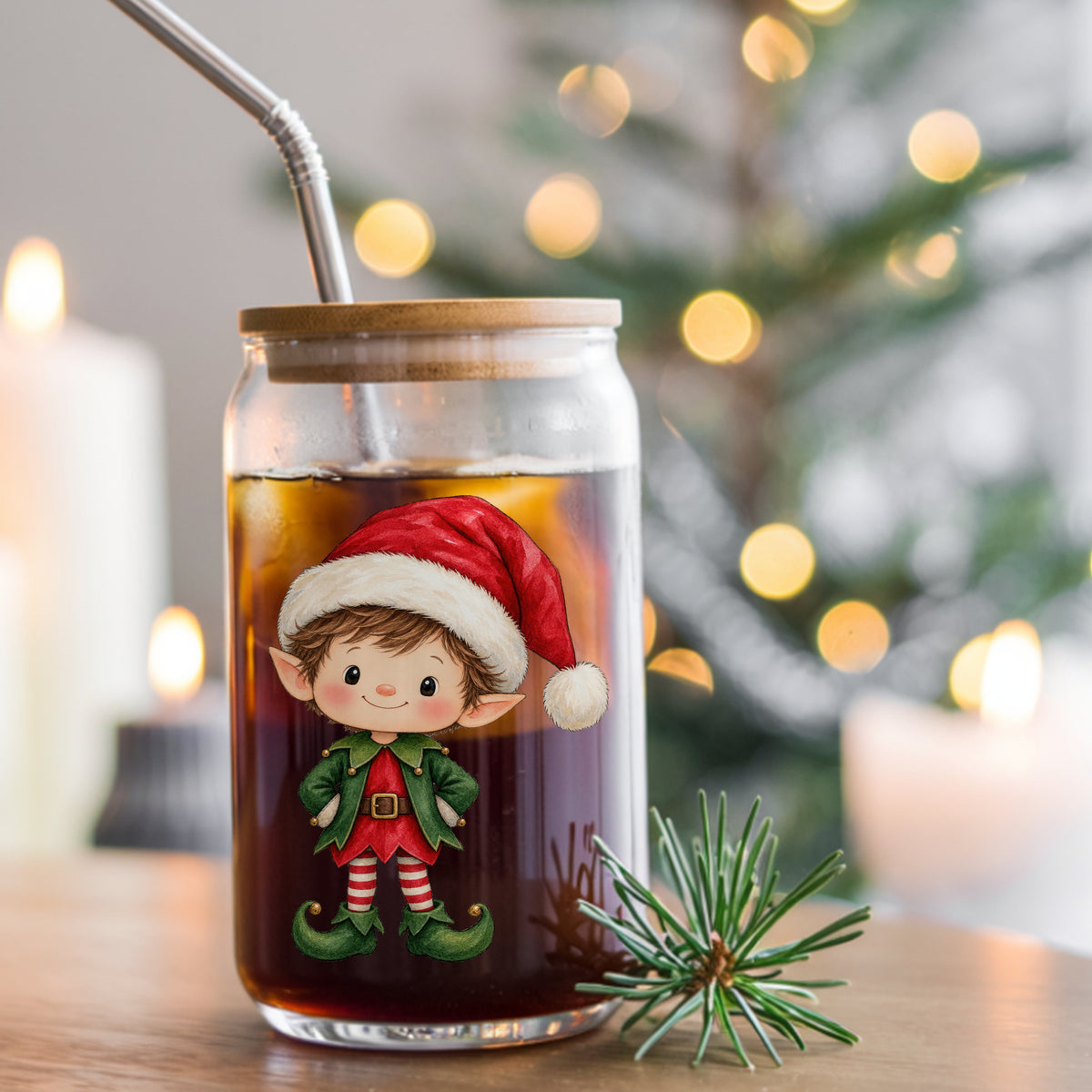 Christmas Elf Boy In Santa Hat UV DTF sticker applied to a glass can cup of iced coffee with a straw