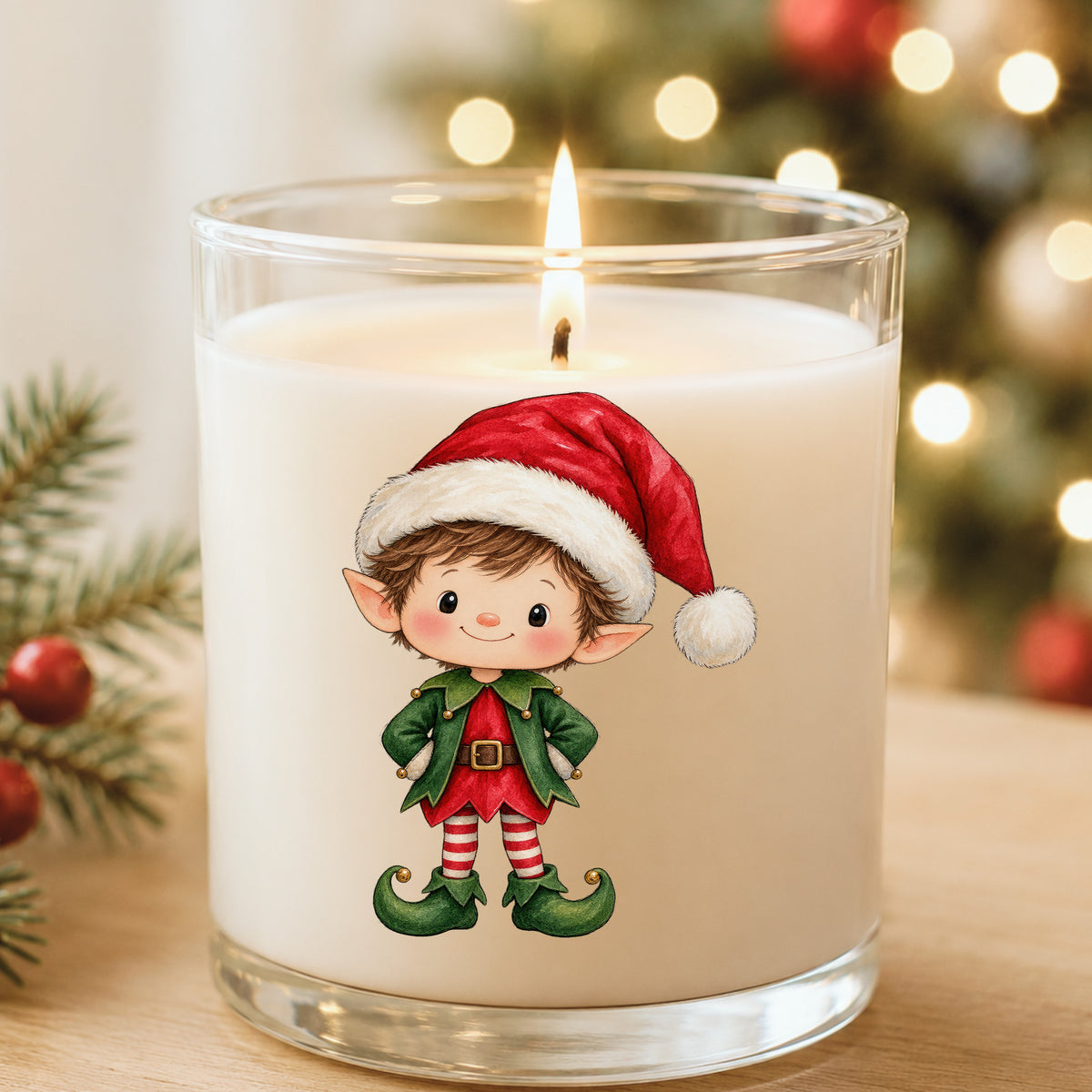 Christmas Elf Boy In Santa Hat UV DTF sticker applied to a white candle in a glass holder near Christmas lights