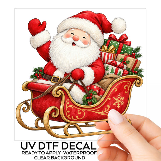 Waving Santa In Sleigh UV DTF sticker on its backing card, held in hand