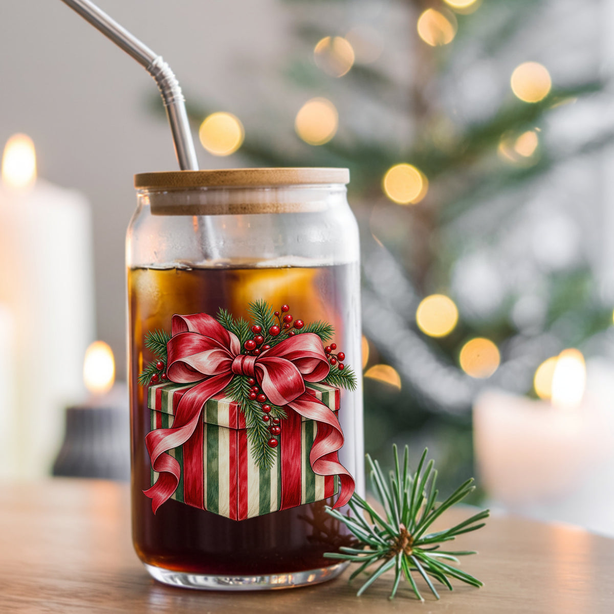 Striped Christmas Gift Box UV DTF sticker applied to a glass can cup of iced coffee with a straw