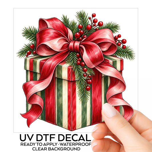 Striped Christmas Gift Box UV DTF sticker on its backing card, held in hand