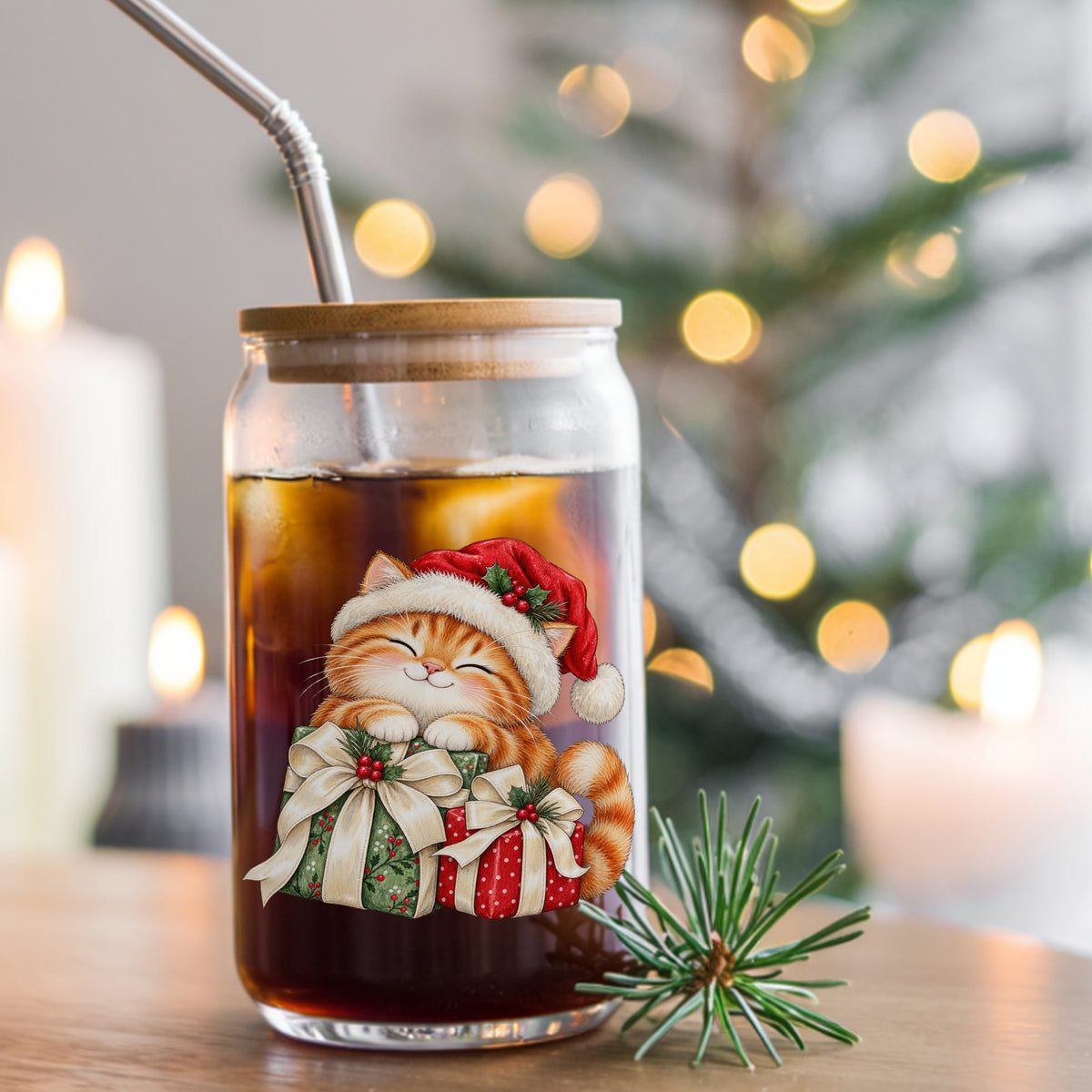 Orange Kitten With Christmas Gifts UV DTF sticker applied to a glass can cup of iced coffee with a straw