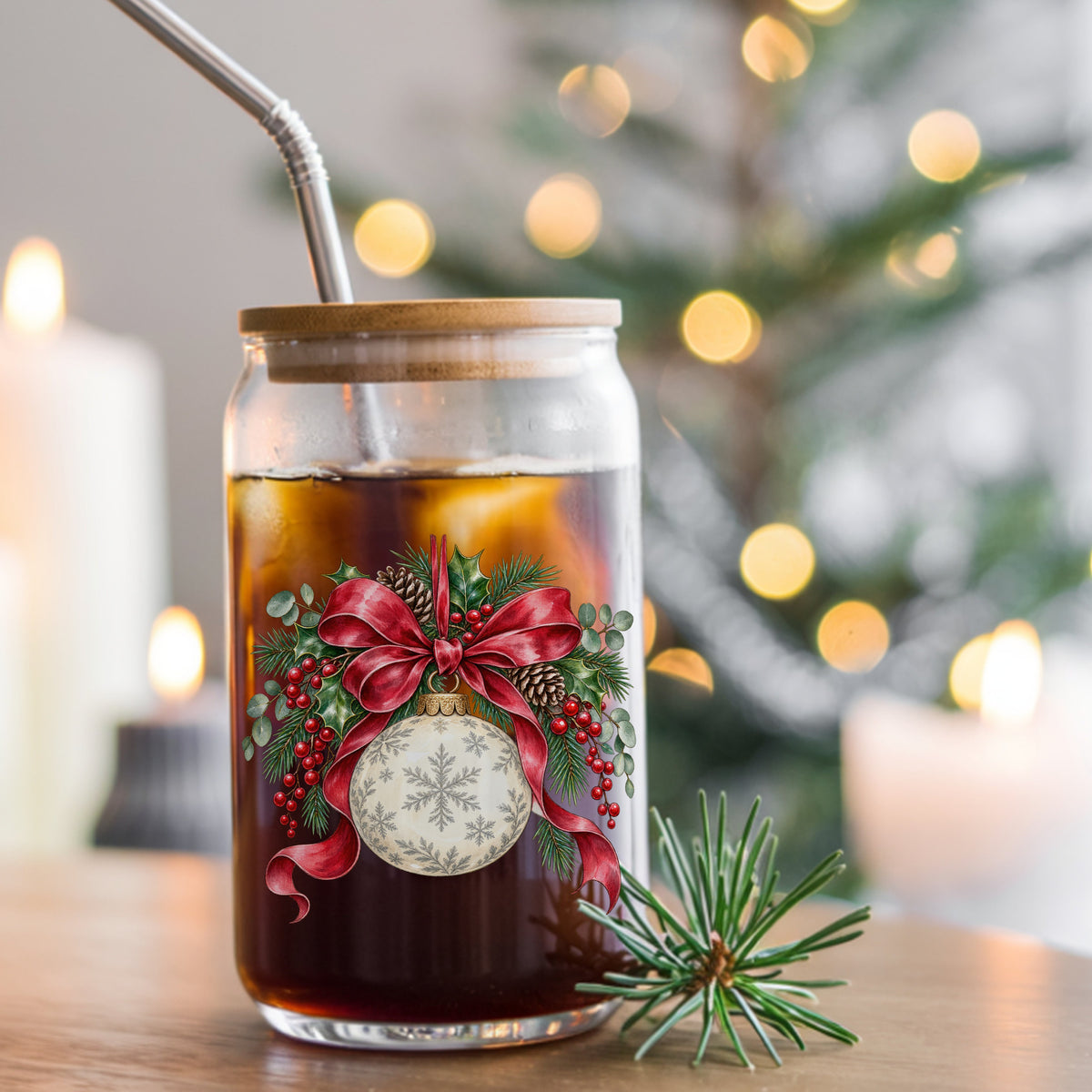 Snowflake Ornament With Red Bow UV DTF sticker applied to a glass can cup of iced coffee with a straw