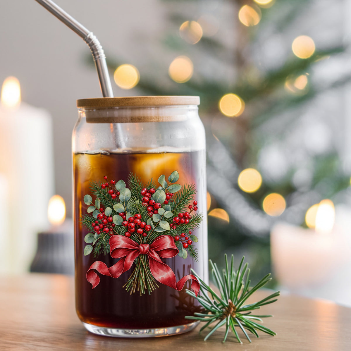 Winter Berry Bouquet With Red Bow UV DTF sticker applied to a glass can cup of iced coffee with a straw