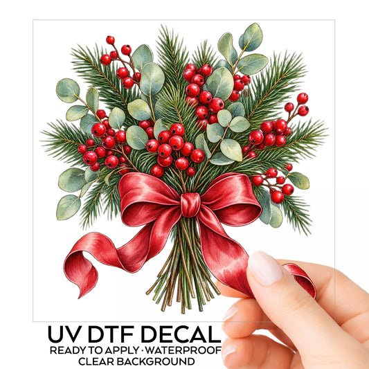 Winter Berry Bouquet With Red Bow UV DTF sticker on its backing card, held in hand