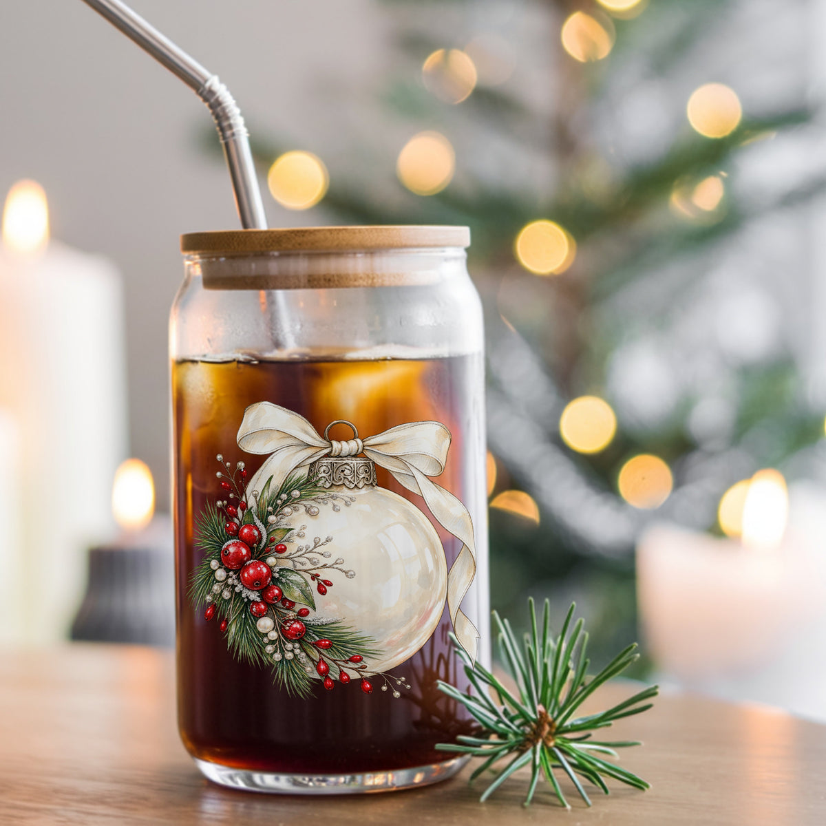 Cream Glass Ornament With Ribbon UV DTF sticker applied to a glass can cup of iced coffee with a straw