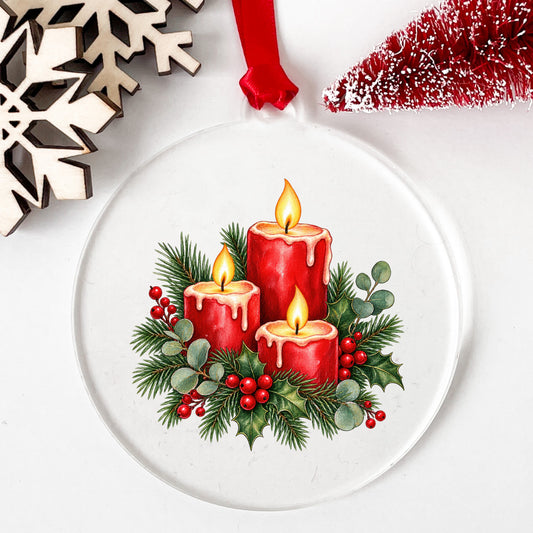 Red Christmas Candles With Greenery UV DTF sticker applied to a clear round acrylic ornament with a red ribbon