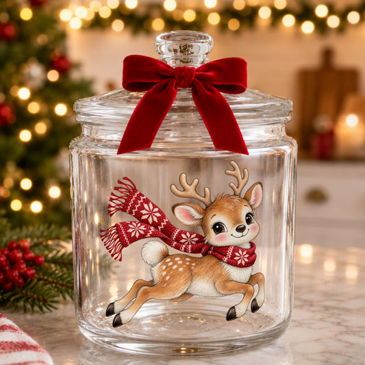 Leaping Reindeer In Nordic Scarf UV DTF sticker applied to a glass candy jar tied with a red bow