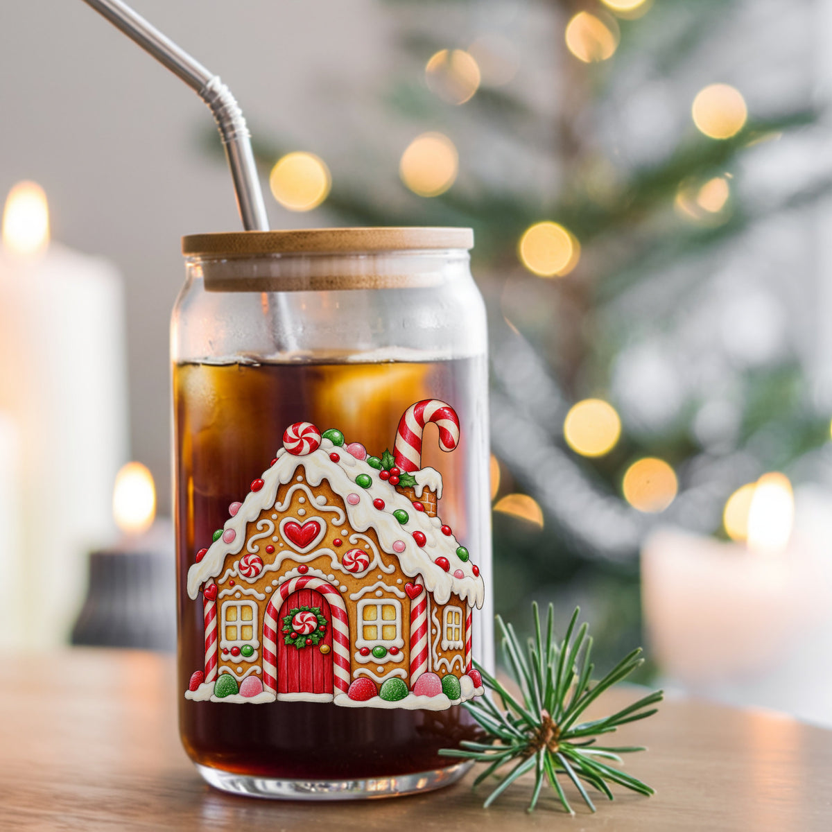 Gingerbread House With Candy UV DTF sticker applied to a glass can cup of iced coffee with a straw