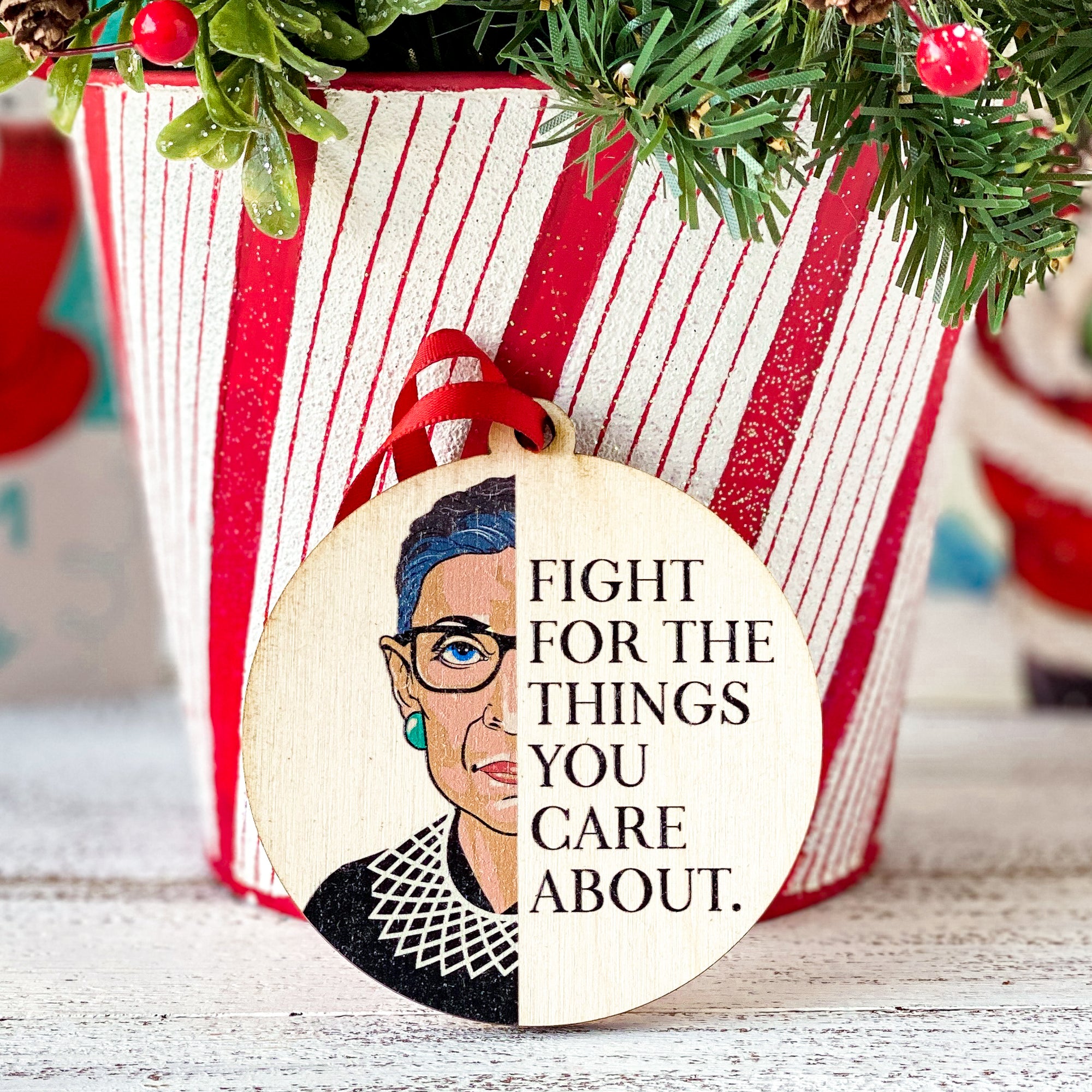 round ornament saying Fight For The Things You Care About and half of Ruth Bader Ginsburg's Face